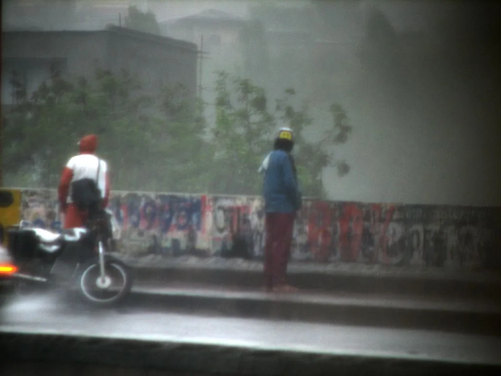 Motor cyclist takes a leak on the fly over bridge